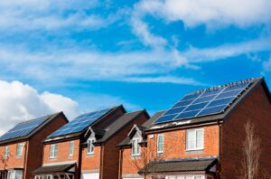 A row of houses with solar panels on the roof